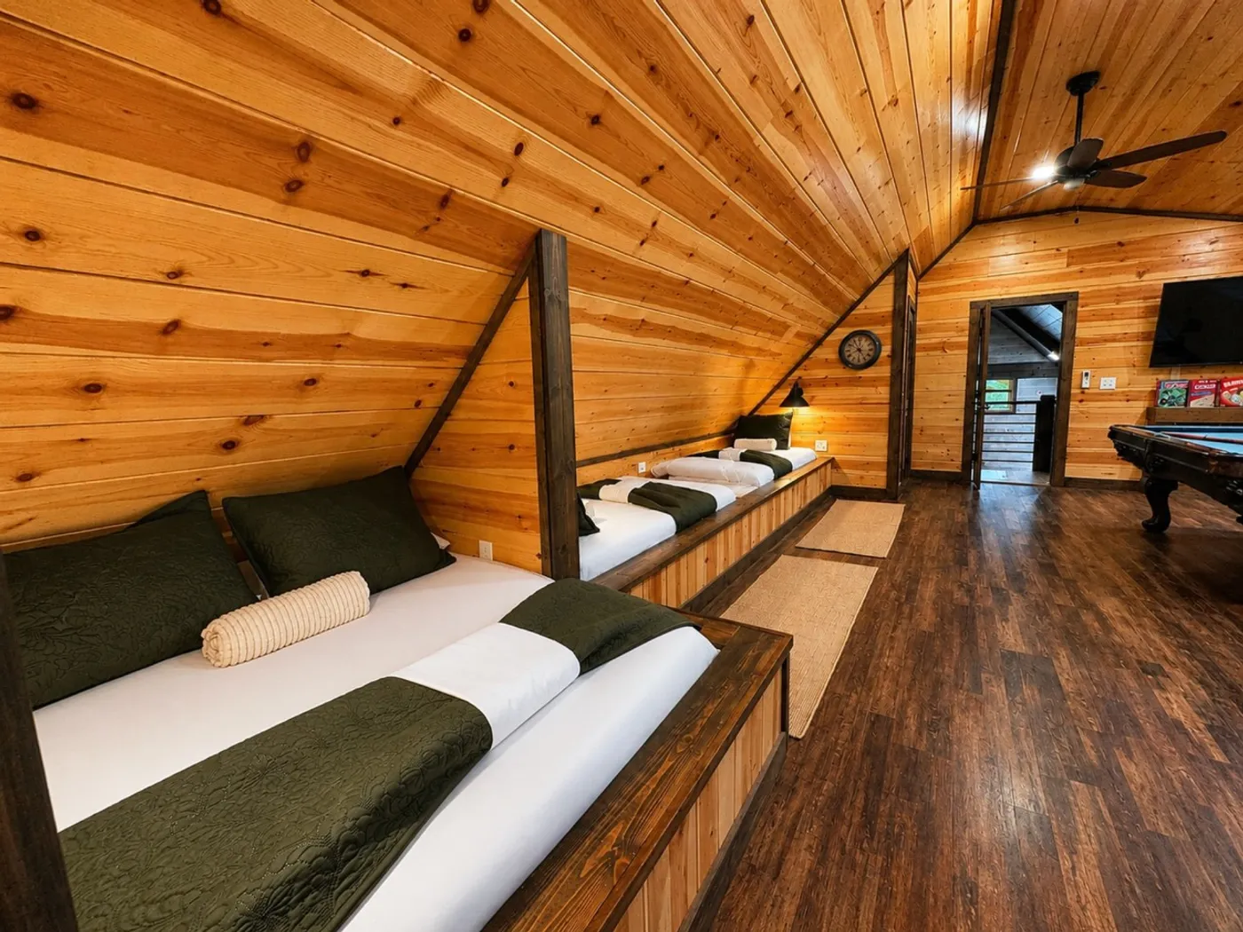 Loft sleeping area with one full bed and two twin beds
