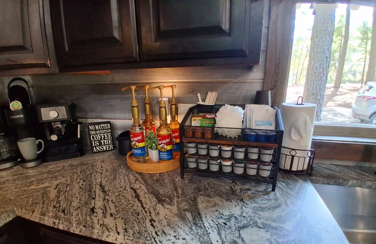 Full coffee bar with Keurig, espresso machine, syrups, creamers and supplies at The Rustic Reserve