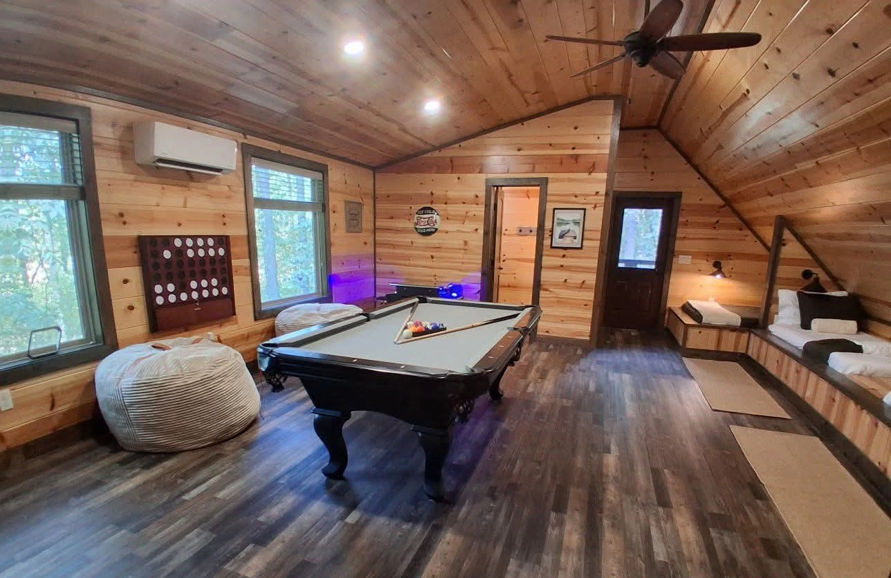 Upstairs loft bedroom and game room with pool table at The Rustic Reserve